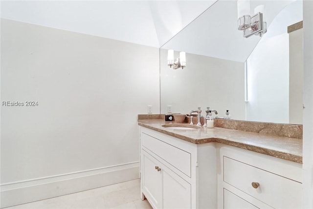 bathroom featuring tile patterned floors, vanity, and a notable chandelier