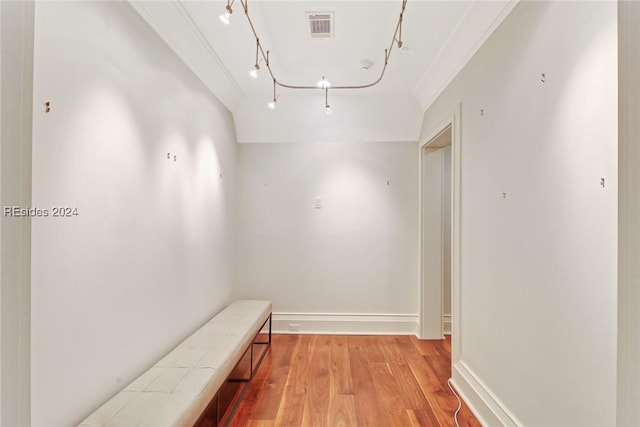 hall with light hardwood / wood-style flooring and ornamental molding