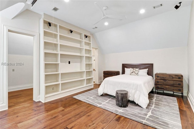 bedroom with wood-type flooring, vaulted ceiling, and ceiling fan