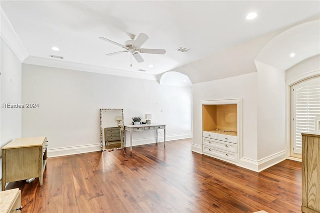 interior space featuring ornamental molding, dark wood-type flooring, and ceiling fan