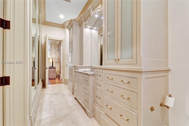 bathroom featuring vanity and ornamental molding