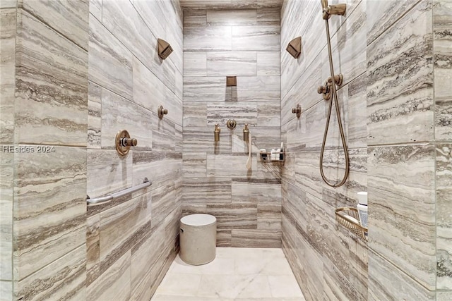 bathroom with tiled shower