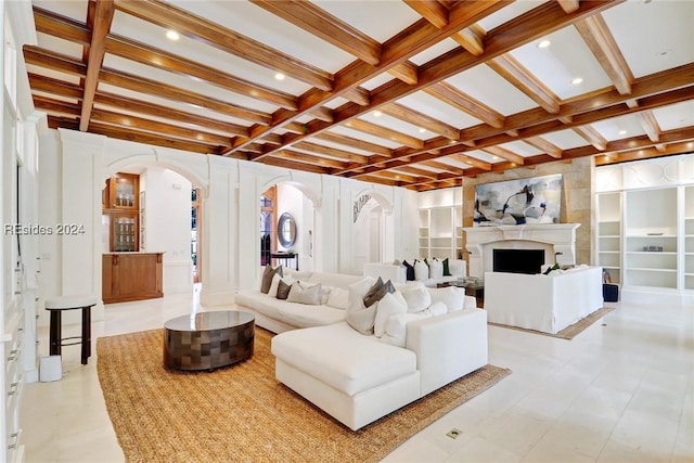 living room featuring coffered ceiling, built in features, and beamed ceiling