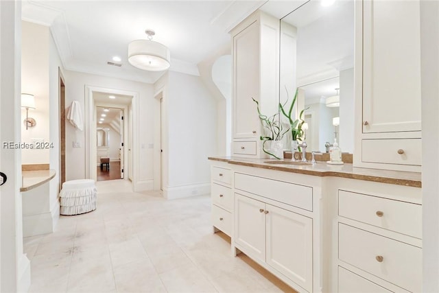 bathroom featuring vanity and ornamental molding