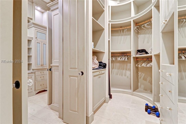 spacious closet with light tile patterned flooring