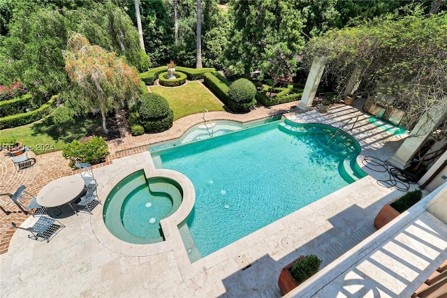 view of pool with a patio and an in ground hot tub