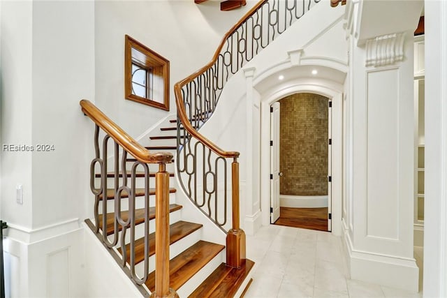 stairs featuring tile patterned flooring