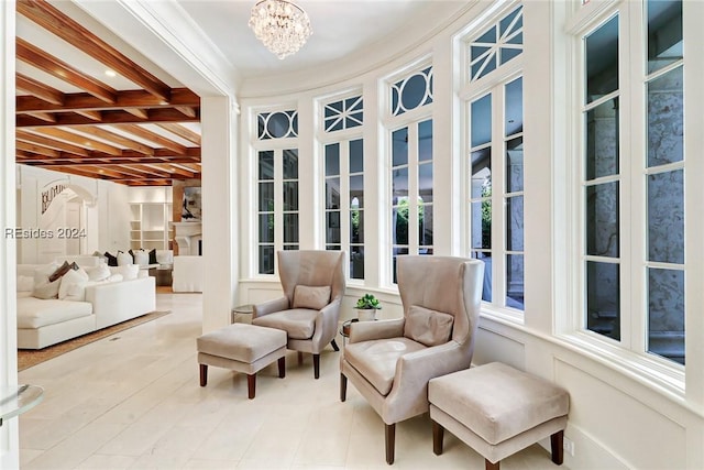 sunroom / solarium with beamed ceiling, a healthy amount of sunlight, coffered ceiling, and an inviting chandelier