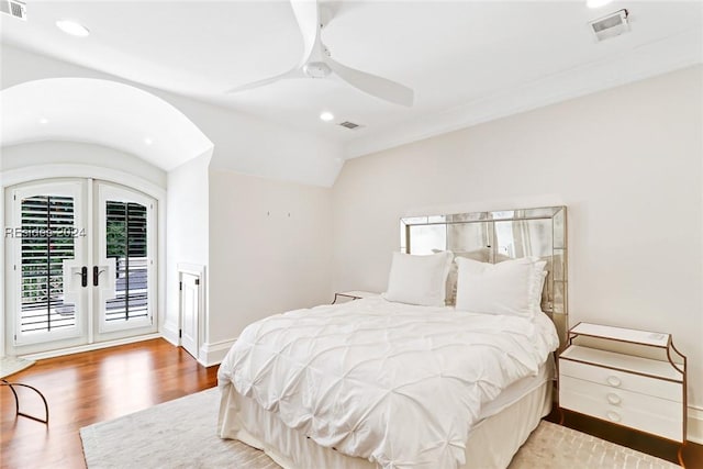 bedroom featuring french doors, wood-type flooring, vaulted ceiling, ceiling fan, and access to exterior