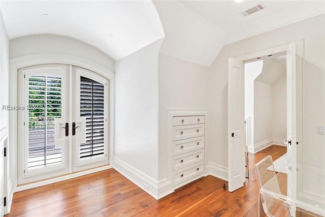 foyer entrance with hardwood / wood-style flooring and lofted ceiling