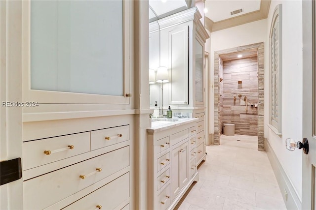 bathroom with vanity, ornamental molding, a shower, and toilet