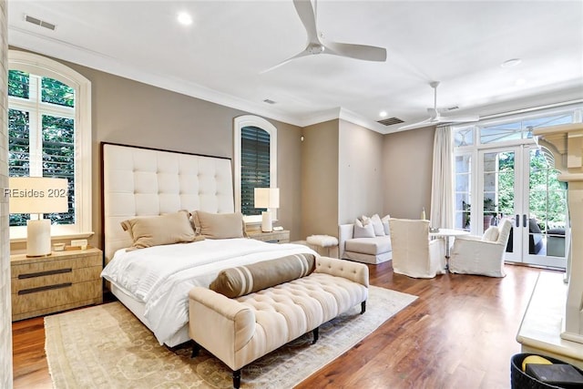 bedroom with hardwood / wood-style flooring, ceiling fan, multiple windows, and access to outside