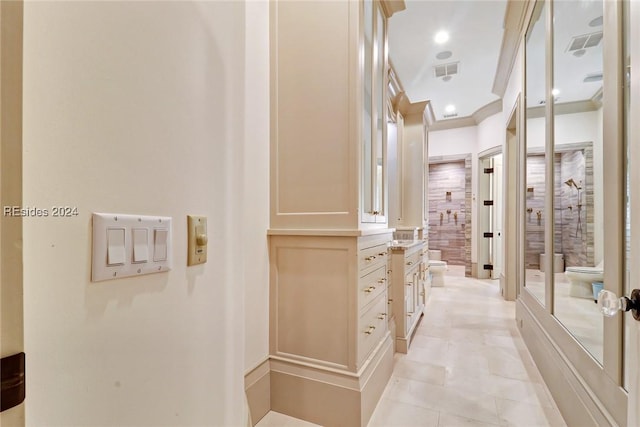 bathroom featuring crown molding and vanity