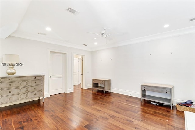 interior space featuring crown molding, dark wood-type flooring, and ceiling fan