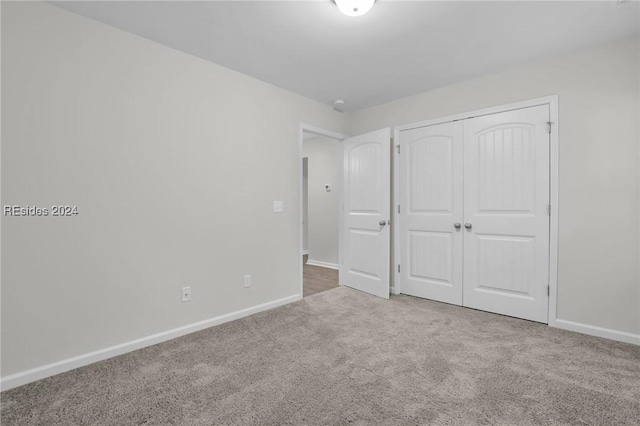 unfurnished bedroom with a closet and carpet flooring