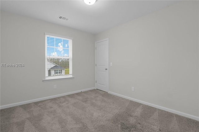 spare room with light colored carpet