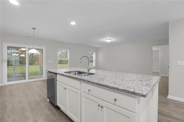 kitchen with sink, hanging light fixtures, stainless steel dishwasher, a kitchen island with sink, and white cabinets