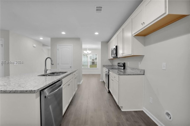 kitchen with dark wood-type flooring, appliances with stainless steel finishes, sink, and white cabinets