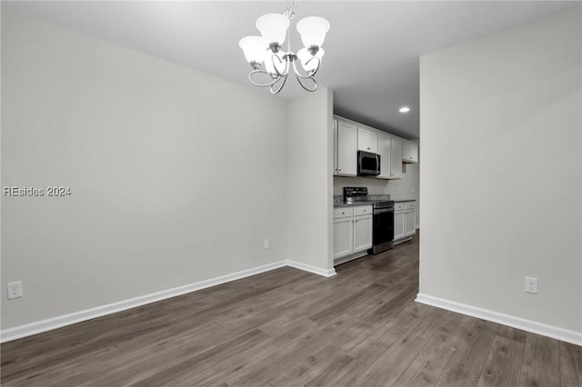 interior space with pendant lighting, a notable chandelier, white cabinets, and appliances with stainless steel finishes