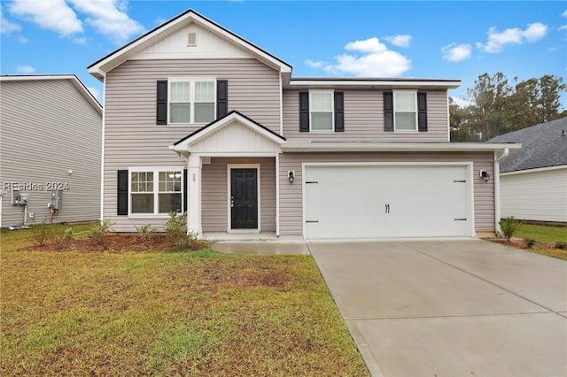 view of front of home featuring a garage and a front lawn