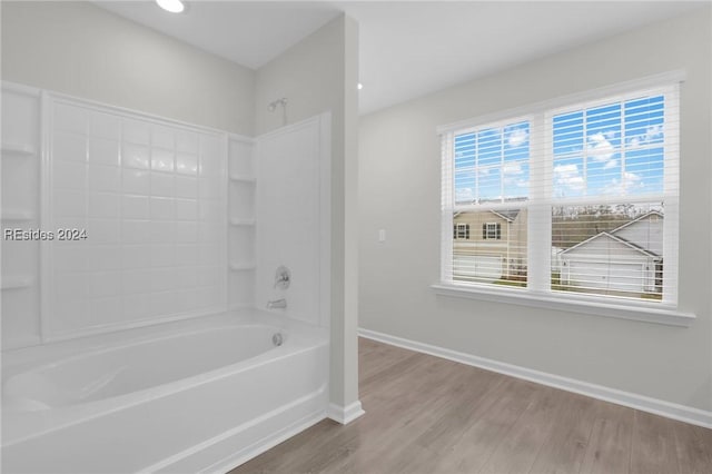 bathroom featuring washtub / shower combination and hardwood / wood-style floors