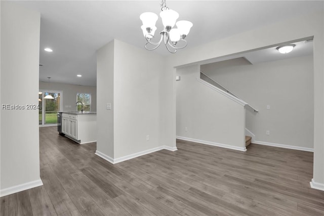 interior space featuring wood-type flooring, sink, and a chandelier