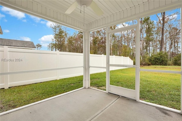 unfurnished sunroom featuring ceiling fan