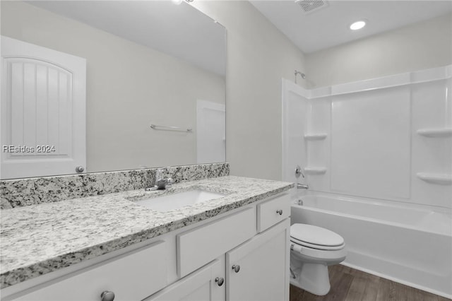 full bathroom with shower / washtub combination, toilet, hardwood / wood-style floors, and vanity