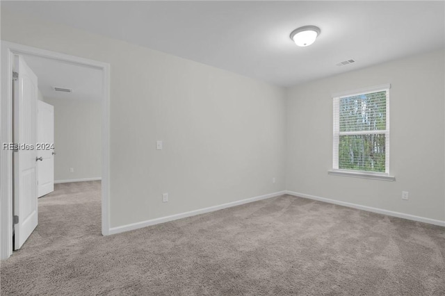 unfurnished room with light colored carpet