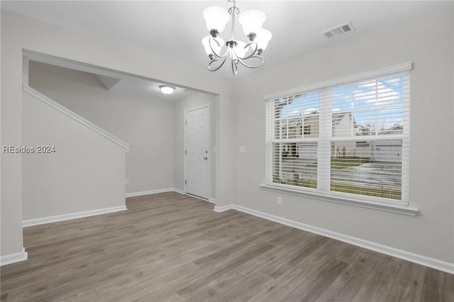 entrance foyer featuring hardwood / wood-style flooring and an inviting chandelier