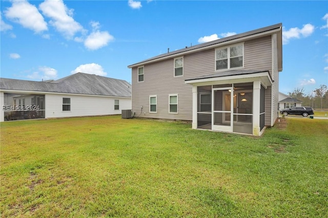 rear view of property with a sunroom, a lawn, and central air condition unit