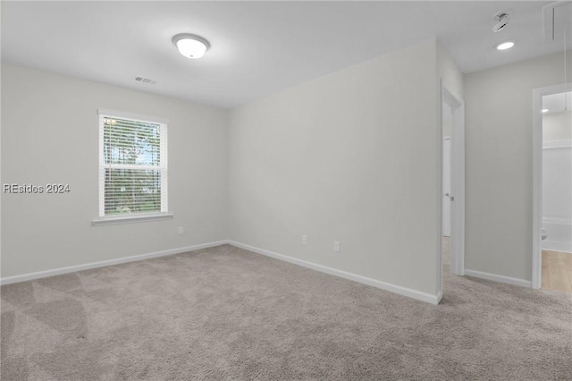 spare room with light colored carpet