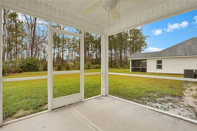 unfurnished sunroom featuring ceiling fan