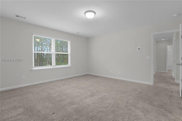 empty room featuring light colored carpet