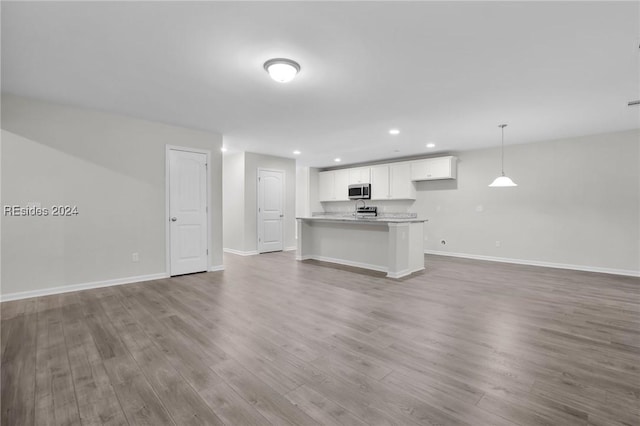 unfurnished living room with wood-type flooring