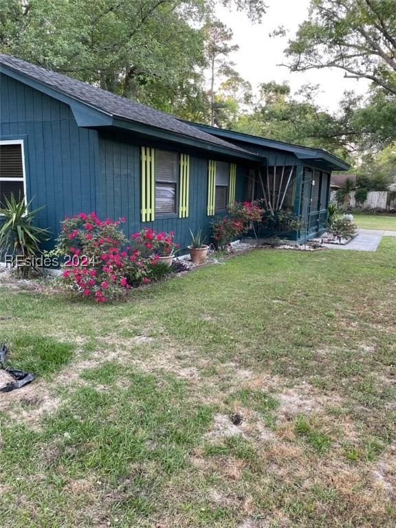 view of side of property with a yard