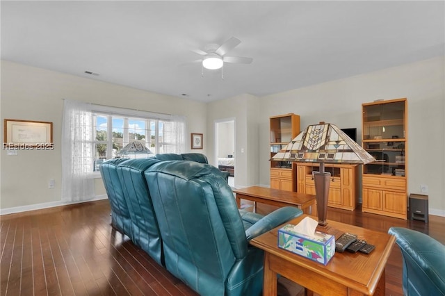 living room with dark wood-type flooring and ceiling fan