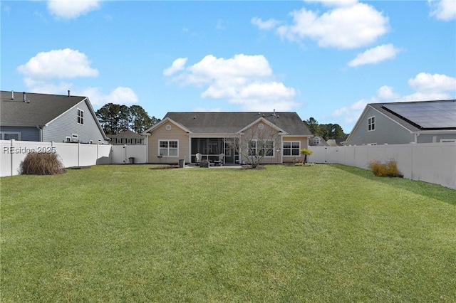 back of property with a lawn and a patio