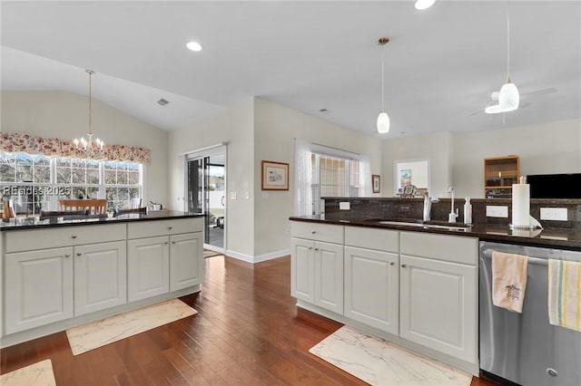 kitchen with lofted ceiling, sink, stainless steel dishwasher, dark hardwood / wood-style flooring, and white cabinets