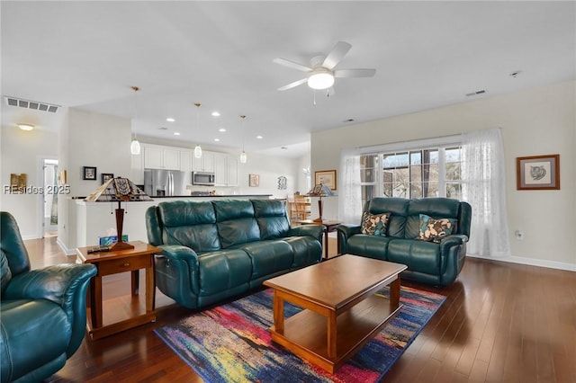 living room with dark wood-type flooring and ceiling fan