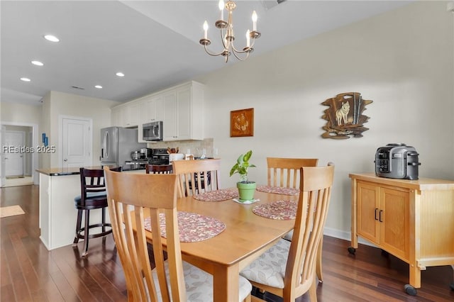 dining room featuring dark wood-type flooring and a chandelier