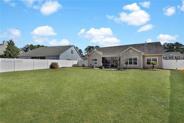 rear view of property featuring a lawn