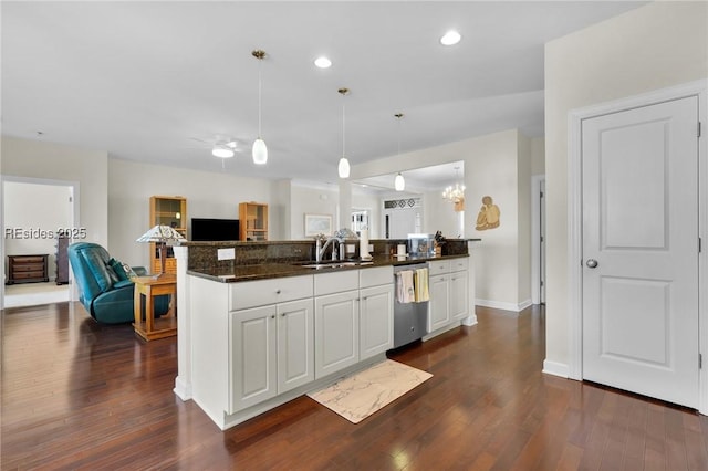 kitchen featuring white cabinetry, dishwasher, sink, and decorative light fixtures