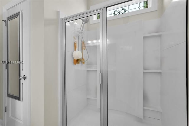 bathroom featuring a shower with shower door