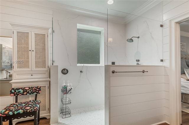 bathroom with crown molding and a shower