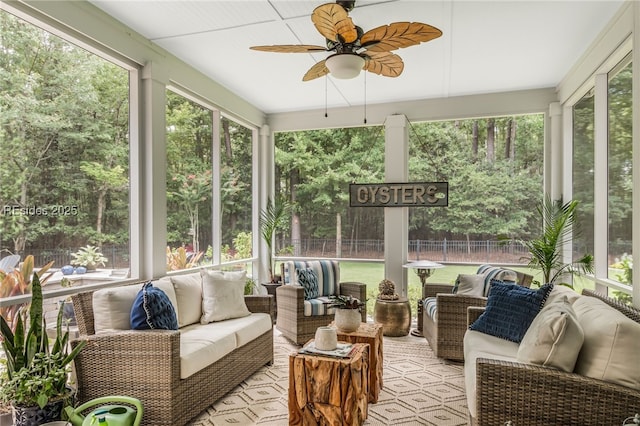 sunroom / solarium featuring ceiling fan