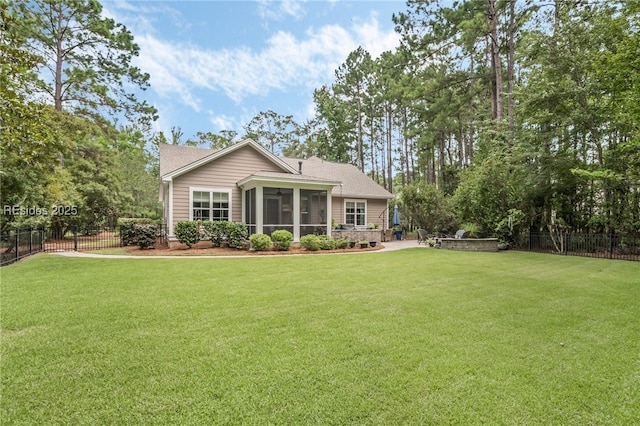 back of property with a sunroom and a yard