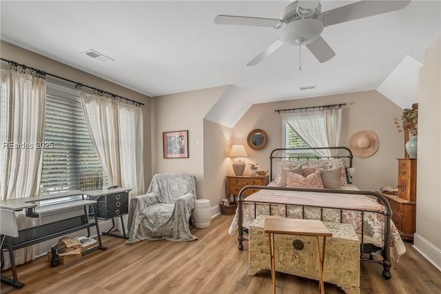 bedroom featuring ceiling fan, lofted ceiling, and hardwood / wood-style floors