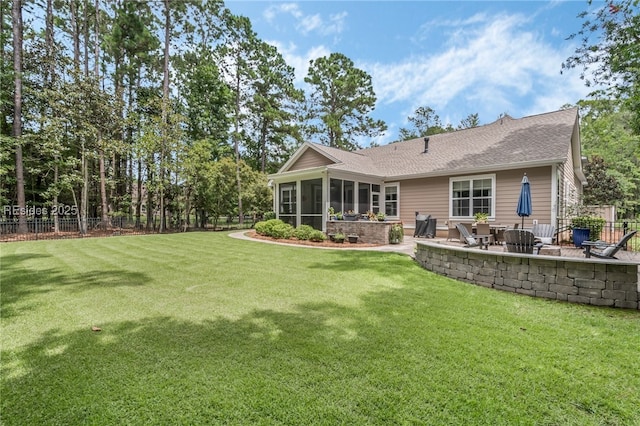 rear view of property with a yard, an outdoor fire pit, a patio area, and a sunroom