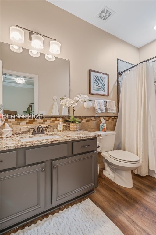 bathroom featuring hardwood / wood-style flooring, vanity, and toilet